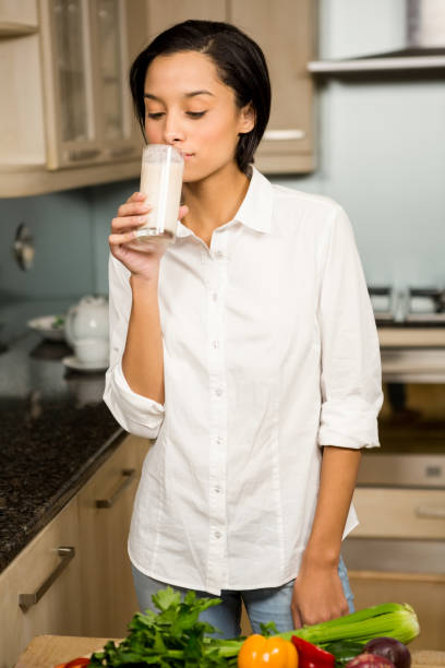 istock Smiling brunette drinking healthy smoothie 674520010
