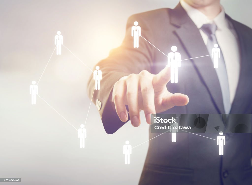 Human resources Businessman touching on screen managing group people icons. HR concept Target Market Stock Photo