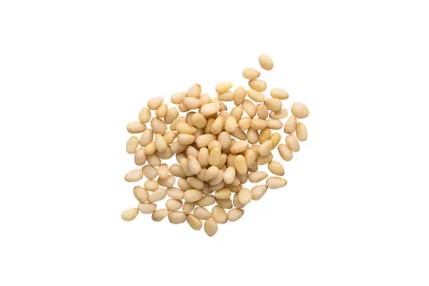 Unshelled pine nuts isolated on a white, food background