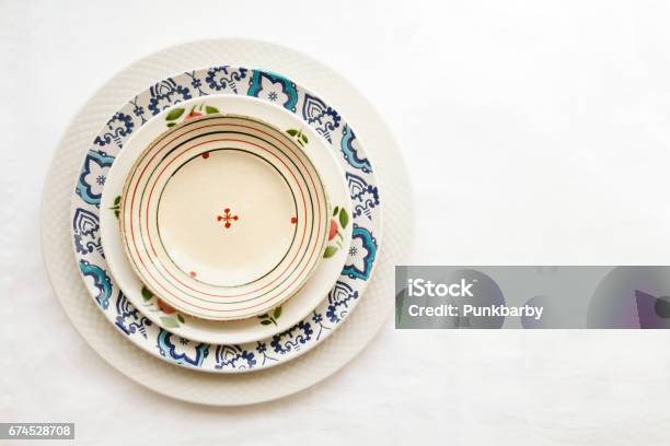 Stack Of Empty Ceramic Plates Isolated On White Background With Copy Space Stock Photo - Download Image Now
