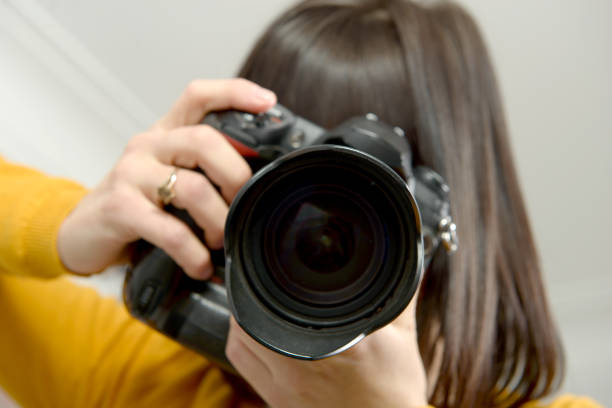 istock Attractive brunette woman with photo camera in studio 674529030