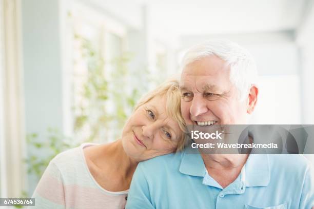 Happy Senior Couple Smiling At Home Stock Photo - Download Image Now - Senior Couple, Senior Adult, Care