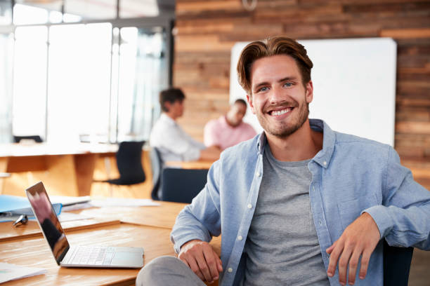 istock Young casually dressed white man in office looking to camera 674555412