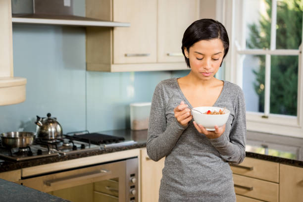 istock Attractive brunette eating cereals 674559214