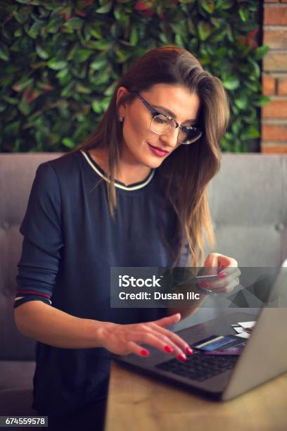 Business Woman Working On Laptop And Using Credi Card Stock Photo - Download Image Now