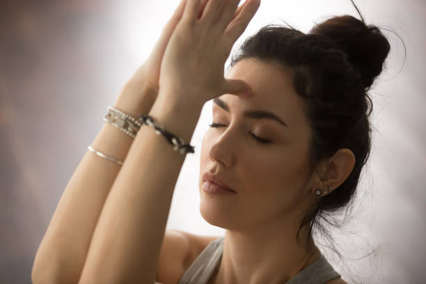 istock Young attractive woman making namaste with closed eyes, studio, 674564248