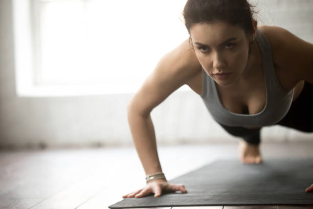 istock Young attractive fitness woman practicing Push ups 674564324