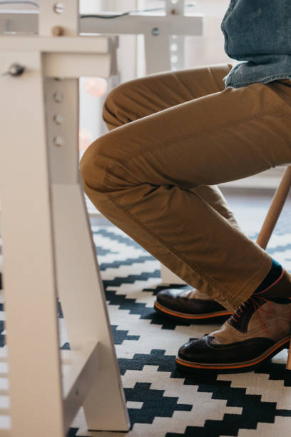 istock Man sitting by the desk is using a laptop 674564728