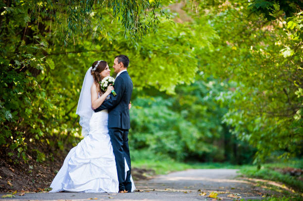 istock Newlyweds stay on green park 674565984