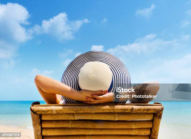 Woman In Hat Relaxing On Beach Looking At Sea Copy Space Stock Photo - Download Image Now