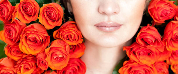 istock Beautiful plump lips with orange roses 674568036