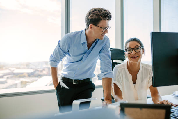 istock Happy business colleagues working together at their desk 674571068