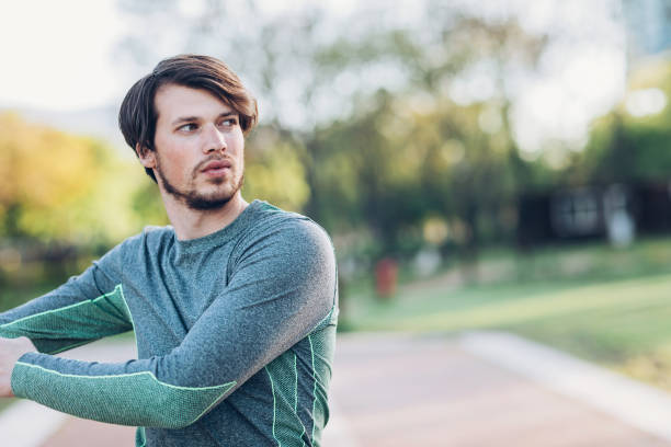 istock Athlete stretching in the park 674571270