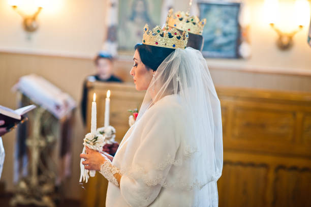 istock Newlyweds at crowns on wedding ceremony at church 674571398