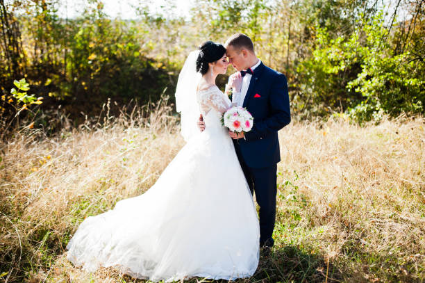 istock Young stylish wedding couple at high grass 674571752