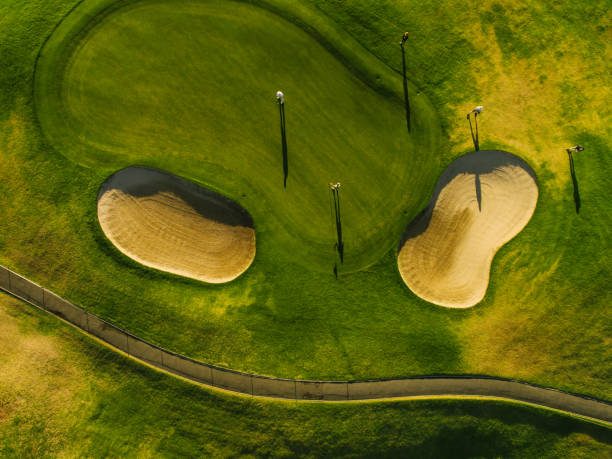 istock Aerial view of beautiful golf course with players 674572090
