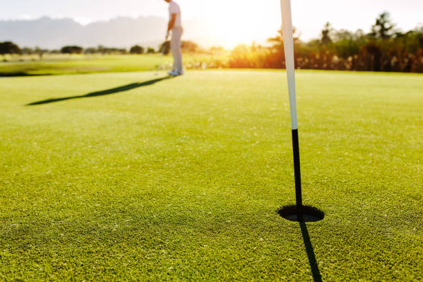istock Golf hole and flag in the green field 674572314