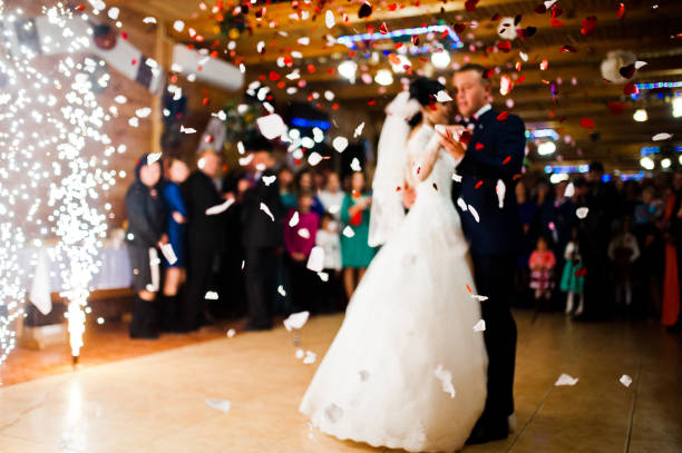 istock First wedding dance with fireworks and confetti, blured focus 674574738