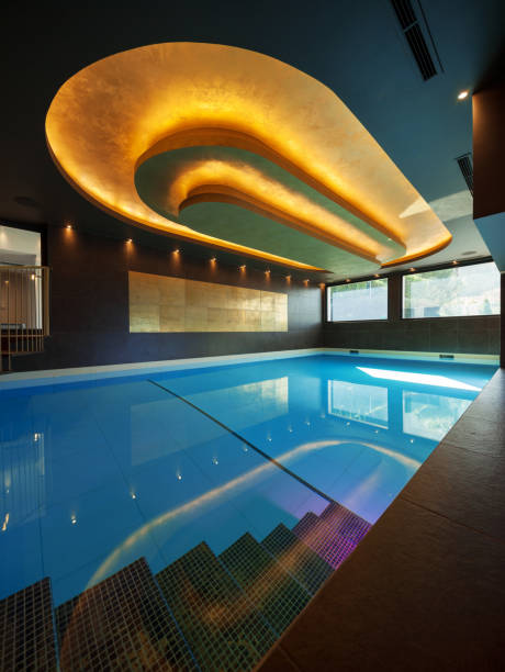 istock Modern swimming pool with water in a luxury villa 674575486