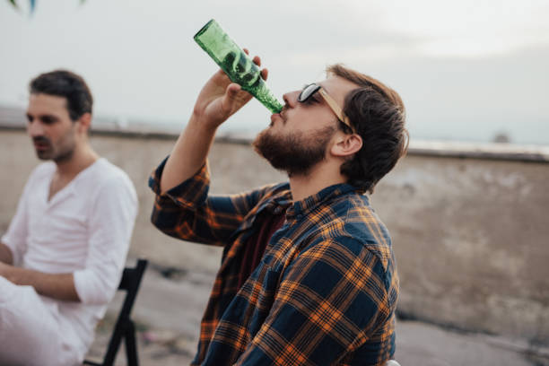 Boys drinking beer and hanging out on the roof