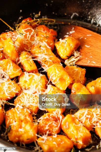 Pumpkin Nokia Gnocchi On Black Pan With Herbs Stock Photo - Download Image Now - Appetizer, Autumn, Baked