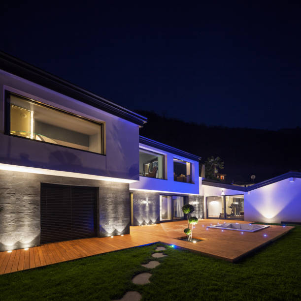 istock Exterior of luxurious modern villa in the night 674581732