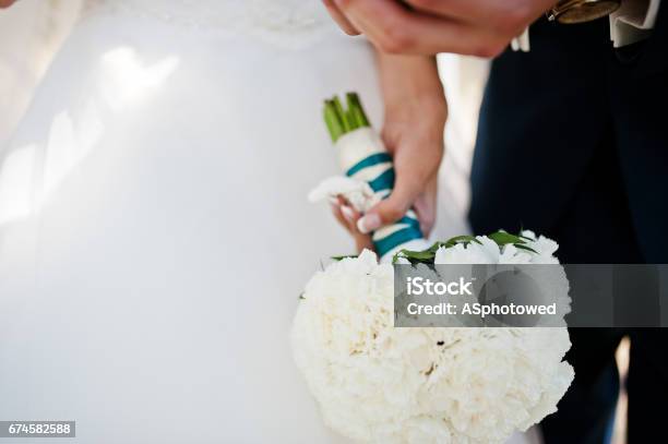 Wedding Bouquet Of White Carnation At Hand Of Bride Stock Photo - Download Image Now