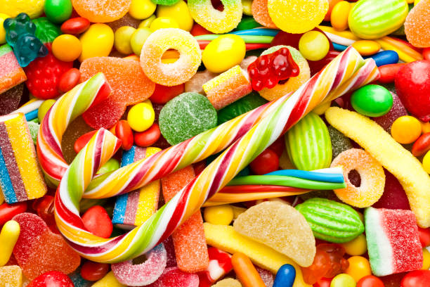 istock Candy canes on colorful candies background 674582650