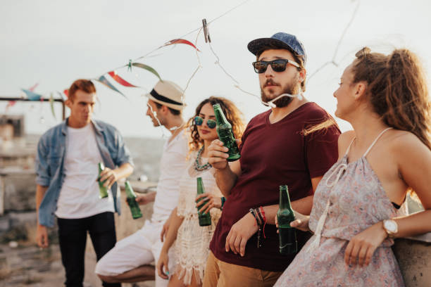 istock Group of people hanging out on the rooftop 674585324