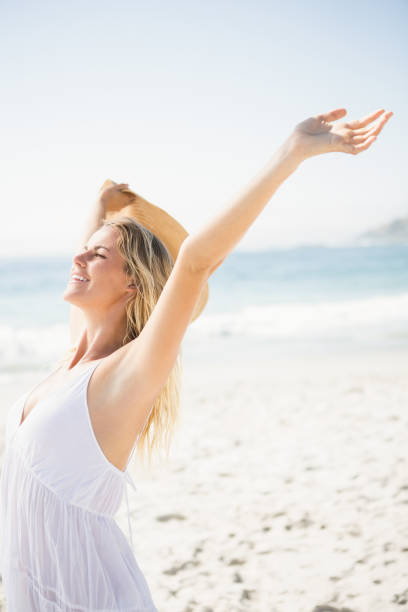 istock Blonde woman relaxing on the beach 674585522