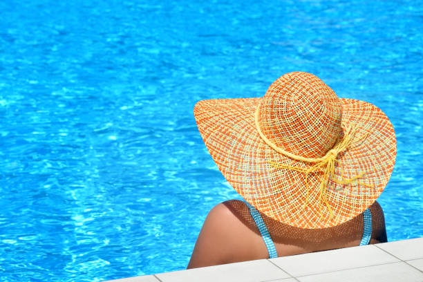 istock Real female beauty relaxing at swimming pool 674585774