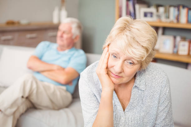 istock Tensed senior couple sitting on sofa 674585776