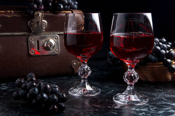 istock Glass of red wine on dark marble background. 674585810