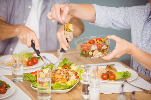 istock Midsection of family having meal 674586204