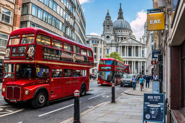 Street in London. HDR style image London: Busy street in central London, with classic retro and new modern double decker buses and St. Paul's Cathedral in the background. HDR style image city of london flag stock pictures, royalty-free photos & images