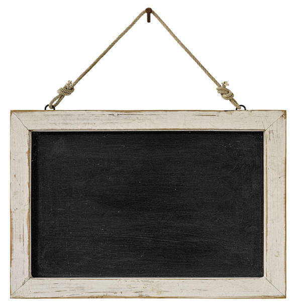 istock Old weathered worn natural wooden white frame blackboard panel, hanging by old rope from a rusty nail isolated on white, clipping path included. 674589248