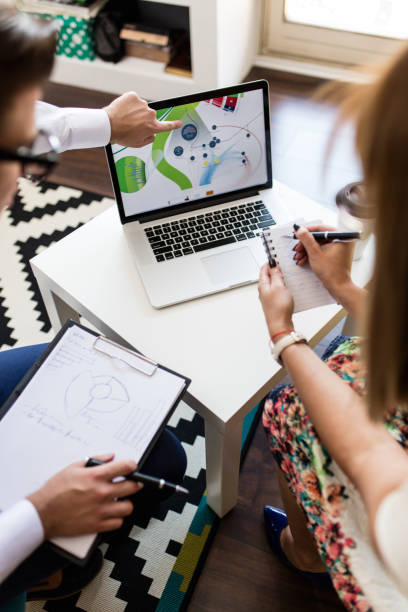 istock Colleagues trying to solve the problem by looking at the laptop 674592082