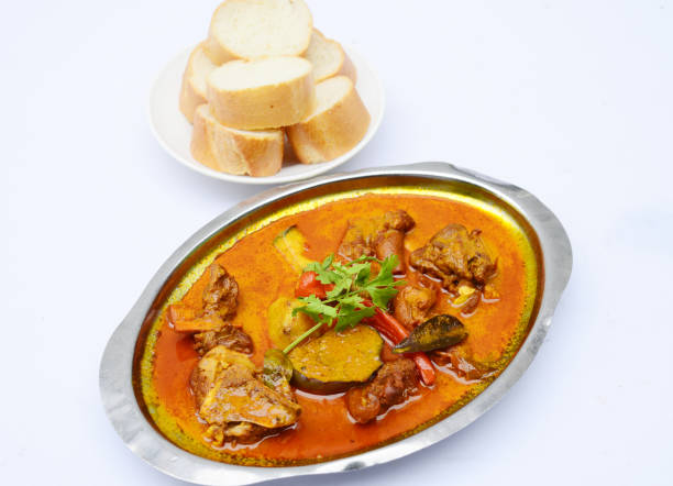 istock Curry soup of goat meat with bread on white background 674592424