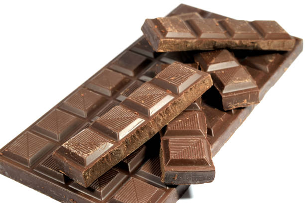 istock Pieces of Chocolate Piled Up on Chocolate Bar Isolated on White 674595190