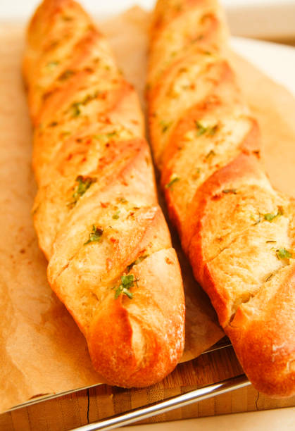 istock French style bread with wrapped paper on wooden board 674595494