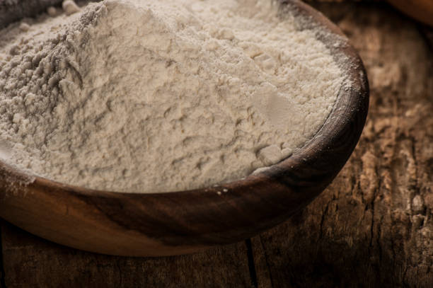 istock white flour in a wooden bowl - rustic style 674595784