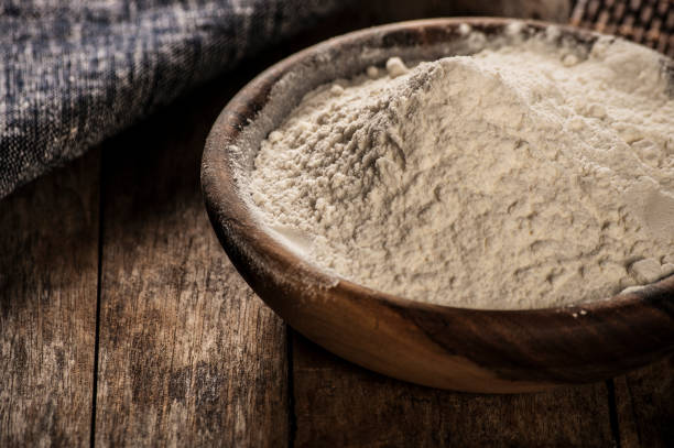 istock white flour in a wooden bowl - rustic style 674595794