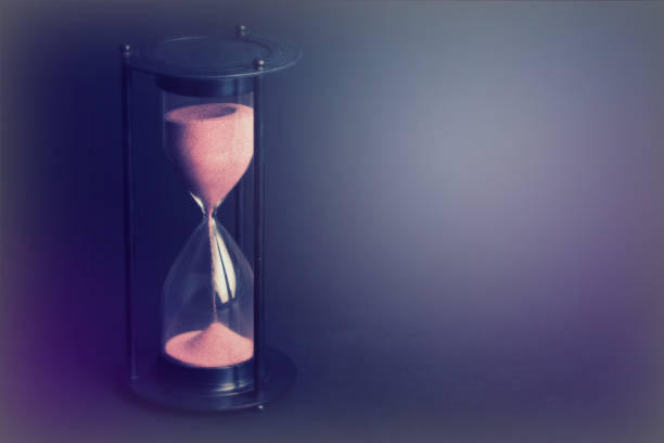 istock Large black hourglass against a black background 674596666