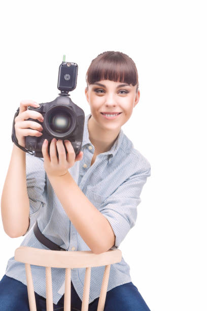 istock Female Photographer Holding a Camera and Smiling. Vertical Image. 674597018