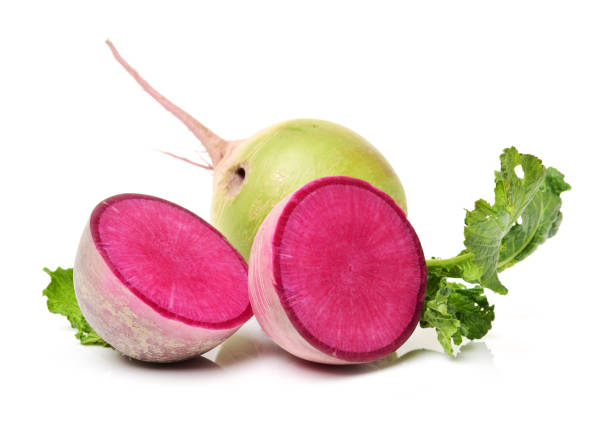 istock One whole and sliced watermelon radish isolated on white background 674599570
