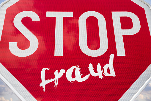 Big red sign and inscription Stop Fraud