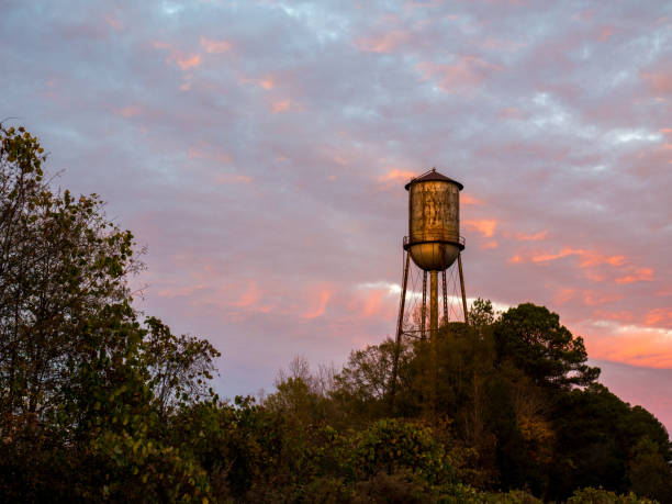 istock Old Small Town Watertower Against a Sunset Sky 674610280
