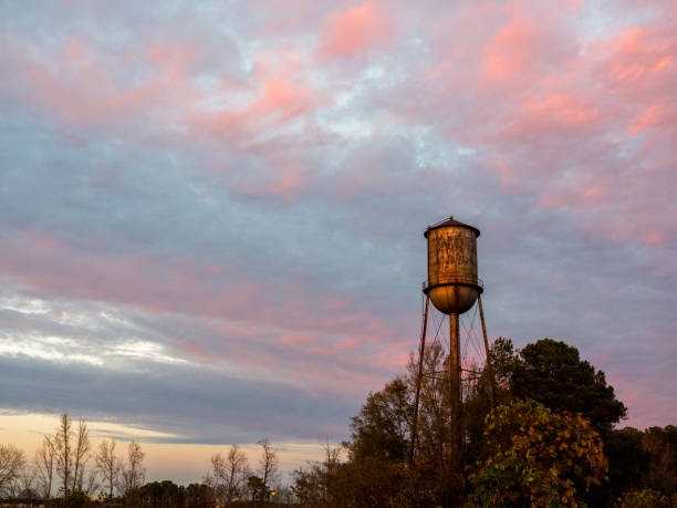 istock Old Small Town Watertower Against a Sunset Sky 674610282