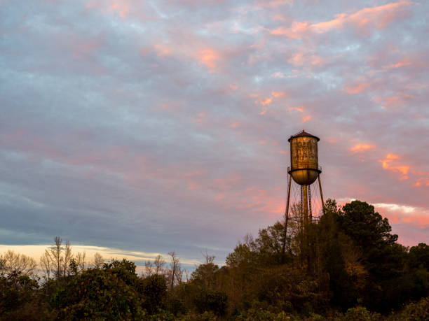 istock Old Small Town Watertower Against a Sunset Sky 674610286