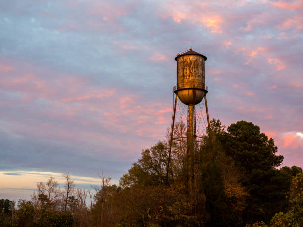 istock Old Small Town Watertower Against a Sunset Sky 674610336